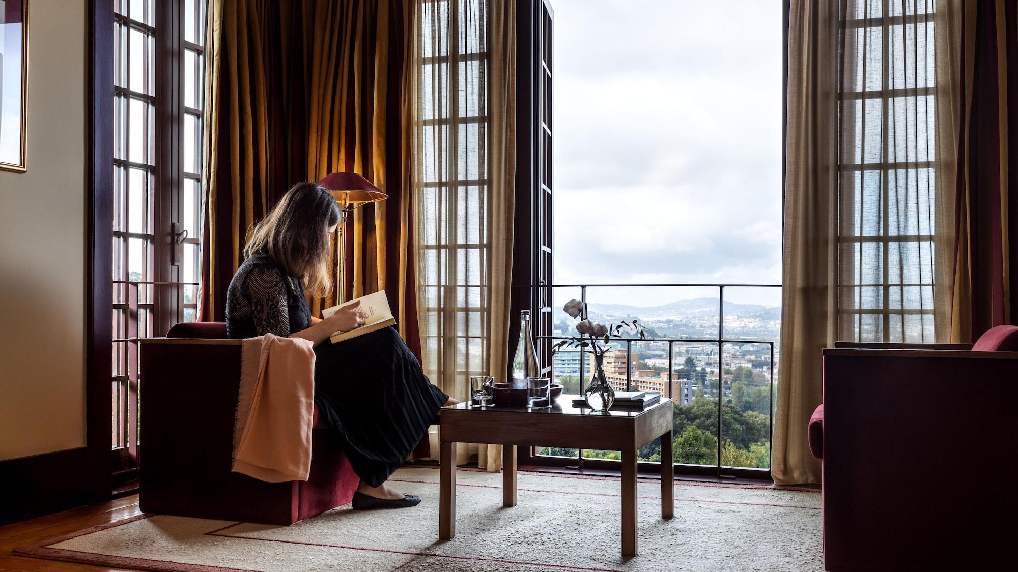Pousada Mosteiro De Guimaraes Bagian luar foto A woman reading in a room